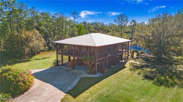 view of yard featuring a sunroom and a carport