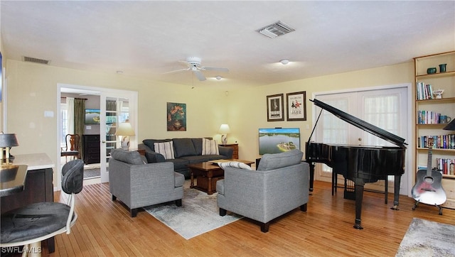 living room featuring french doors, light hardwood / wood-style flooring, and ceiling fan