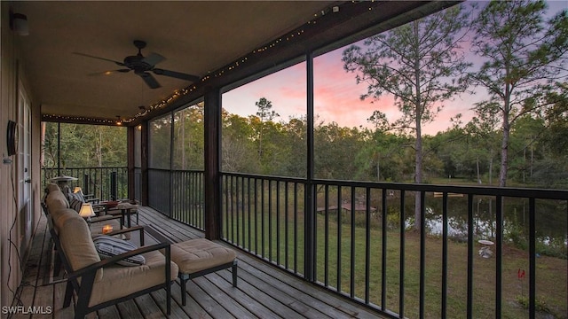 sunroom featuring ceiling fan