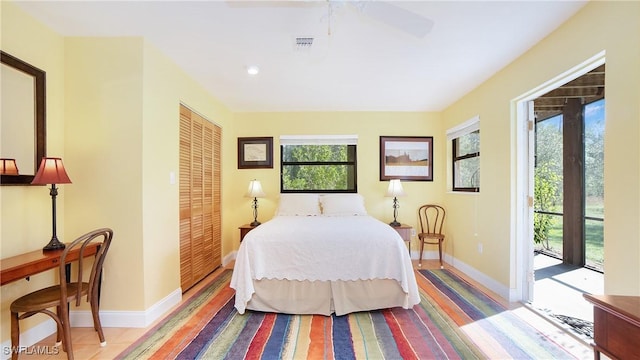 bedroom featuring access to exterior, a closet, and ceiling fan