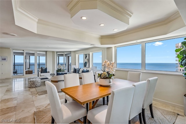 dining area with a water view and crown molding