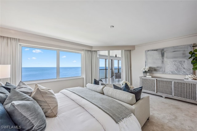 bedroom with a water view, crown molding, radiator, and light colored carpet