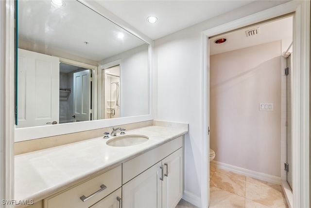 bathroom featuring tile patterned flooring, vanity, and toilet