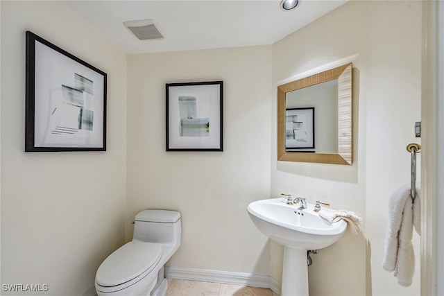 bathroom with tile patterned flooring and toilet