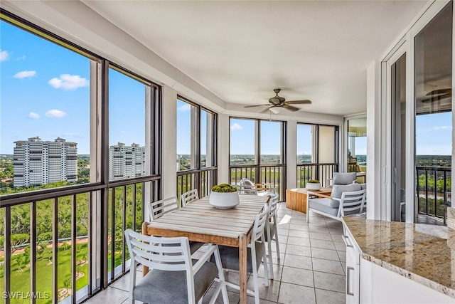 sunroom featuring ceiling fan