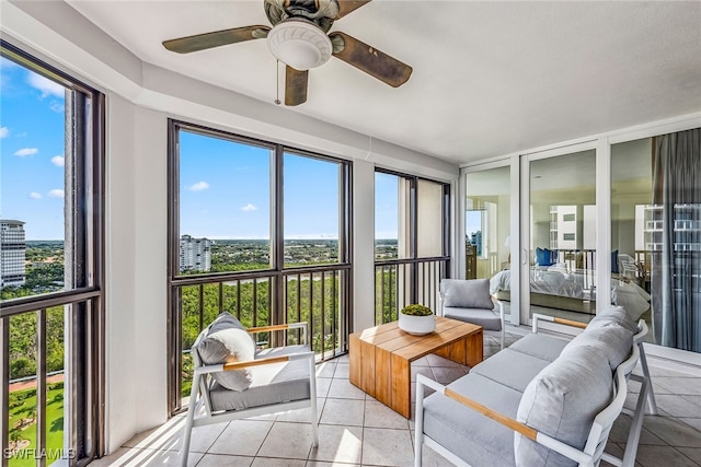 sunroom featuring ceiling fan