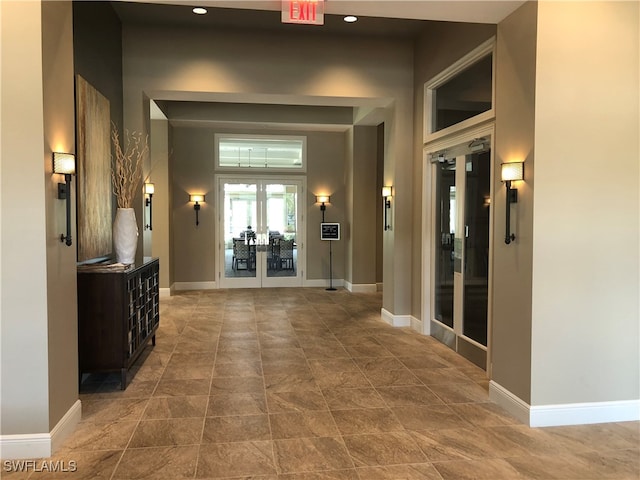 hallway with elevator and french doors