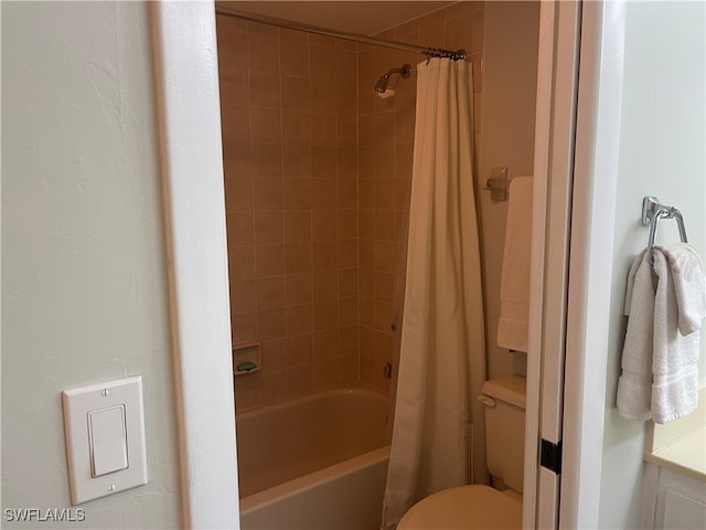 bathroom featuring toilet and shower / tub combo with curtain