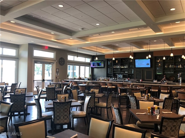 interior space with french doors, coffered ceiling, beamed ceiling, hardwood / wood-style floors, and bar