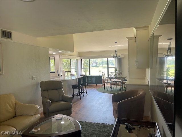 living room featuring hardwood / wood-style floors and a chandelier