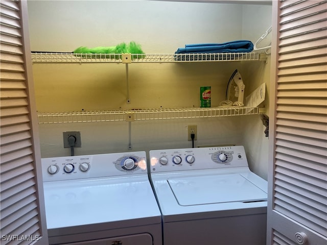 clothes washing area featuring washer and clothes dryer