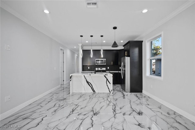 kitchen featuring backsplash, ornamental molding, stainless steel appliances, a kitchen island with sink, and decorative light fixtures