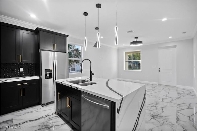 kitchen with a healthy amount of sunlight, stainless steel appliances, a center island with sink, and sink