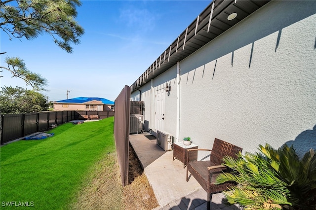 view of yard featuring cooling unit and a patio area