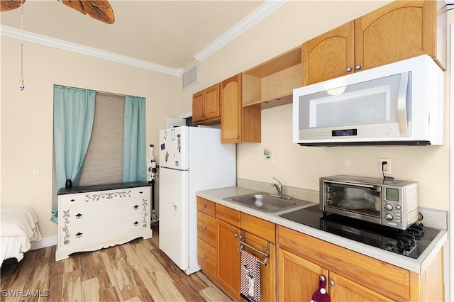 kitchen featuring white appliances, light hardwood / wood-style floors, ornamental molding, and sink