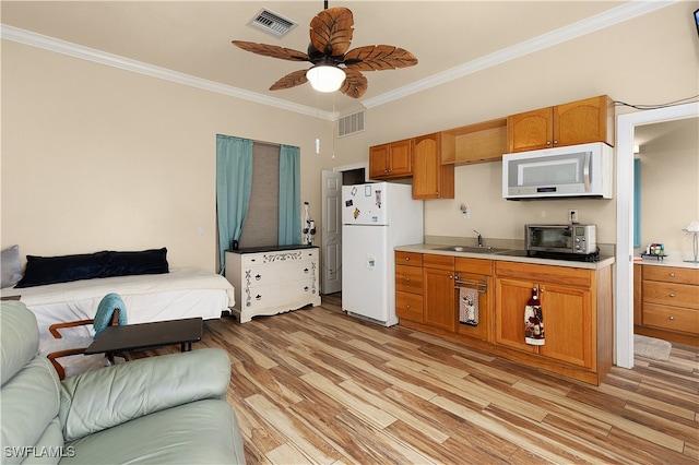 kitchen featuring sink, light wood-type flooring, white appliances, and ornamental molding