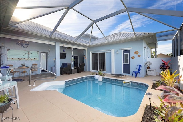 view of pool featuring a patio and glass enclosure