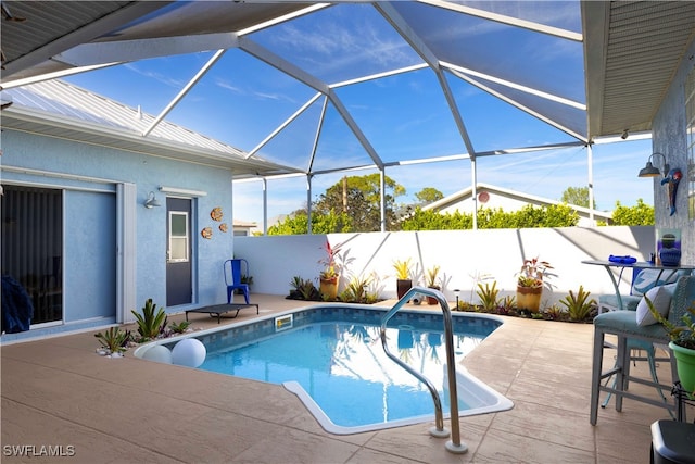 view of pool with a patio area and a lanai