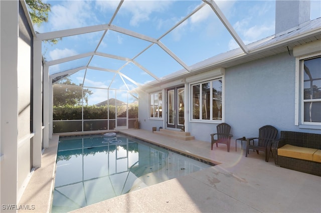 view of swimming pool with a lanai and a patio area