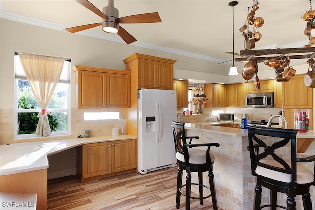 kitchen with decorative backsplash, ceiling fan, white refrigerator with ice dispenser, light hardwood / wood-style floors, and hanging light fixtures