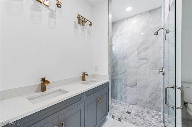 bathroom with a shower with door, vanity, and toilet