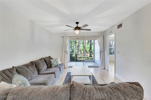 living room with ceiling fan and light hardwood / wood-style floors