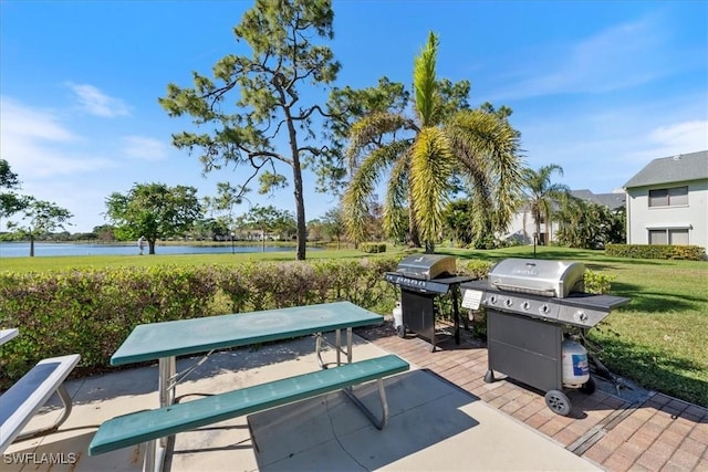 view of patio / terrace with a water view and a grill