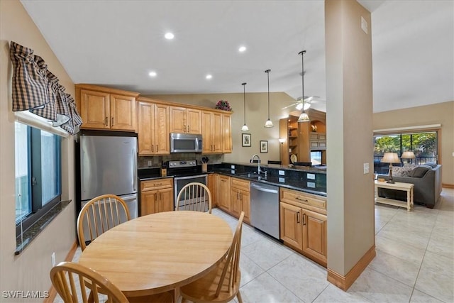 kitchen featuring sink, hanging light fixtures, light tile patterned floors, appliances with stainless steel finishes, and kitchen peninsula