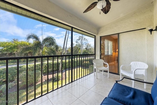 sunroom with ceiling fan and lofted ceiling