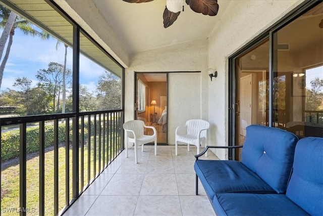 sunroom with ceiling fan and vaulted ceiling