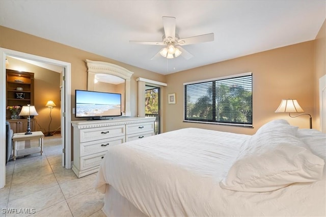 tiled bedroom featuring ceiling fan