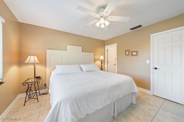 bedroom with ceiling fan and light tile patterned floors