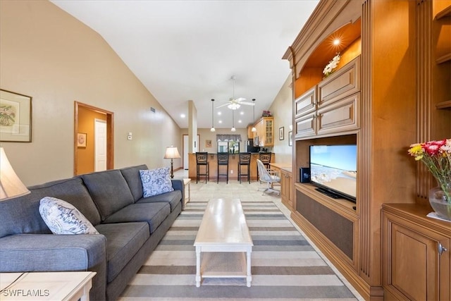 living room featuring vaulted ceiling and ceiling fan