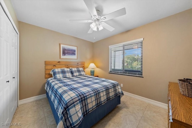 bedroom featuring light tile patterned flooring, a closet, and ceiling fan