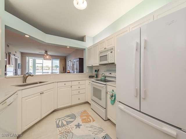 kitchen with light tile patterned flooring, white appliances, tasteful backsplash, and sink