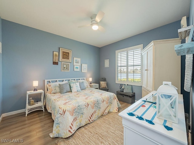 bedroom with ceiling fan and light hardwood / wood-style flooring