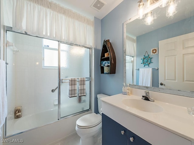 full bathroom featuring shower / bath combination with glass door, vanity, and toilet