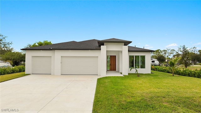 prairie-style house featuring a front lawn and a garage