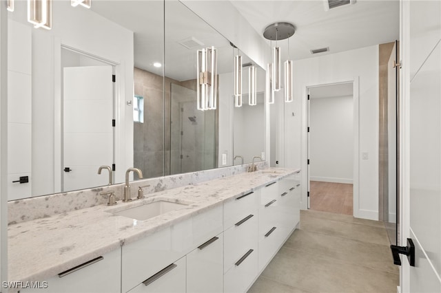 bathroom featuring vanity and an enclosed shower