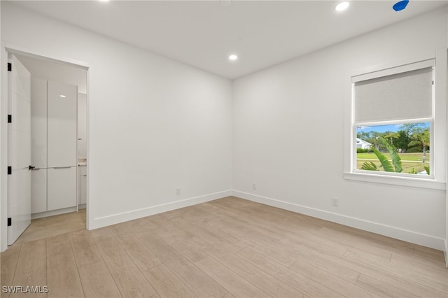 unfurnished room with light hardwood / wood-style floors