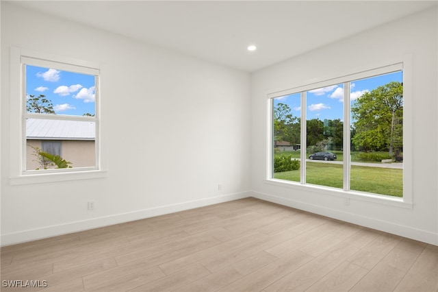 spare room featuring light hardwood / wood-style floors