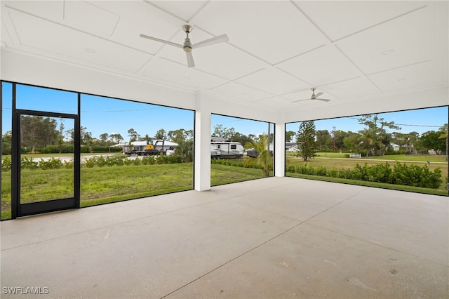 unfurnished sunroom with ceiling fan