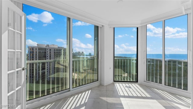 unfurnished sunroom with plenty of natural light and a water view