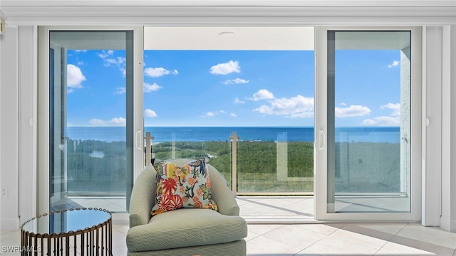 doorway to outside with plenty of natural light, light tile patterned flooring, and a water view