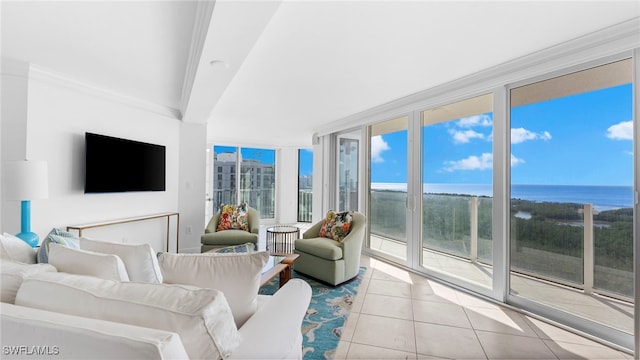 tiled living room featuring floor to ceiling windows, a water view, and crown molding