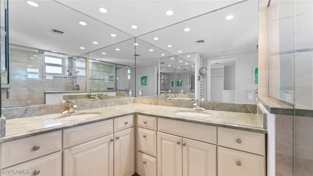 bathroom with vanity and a shower with door