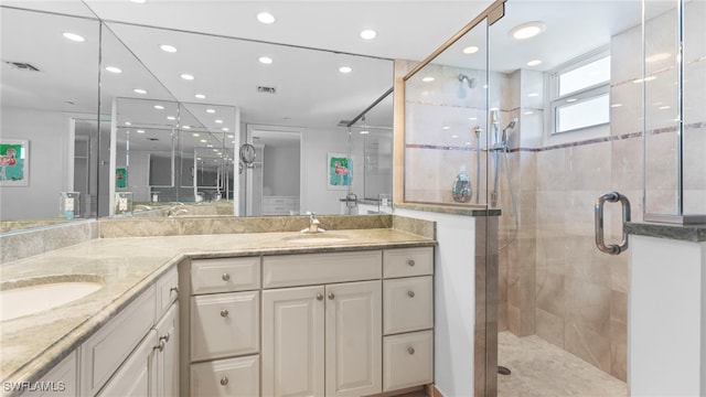 bathroom featuring vanity and a shower with shower door