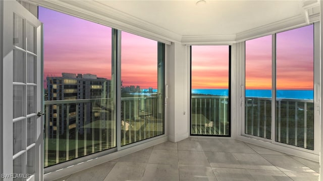 unfurnished sunroom featuring a healthy amount of sunlight and a water view