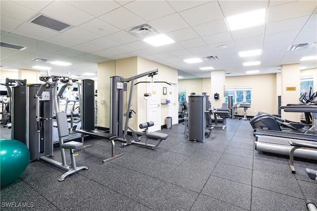 exercise room featuring a drop ceiling