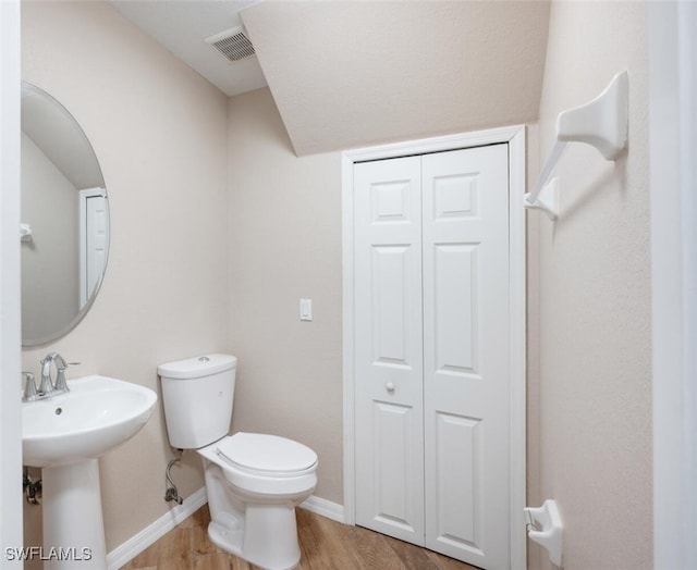 bathroom with sink, wood-type flooring, and toilet